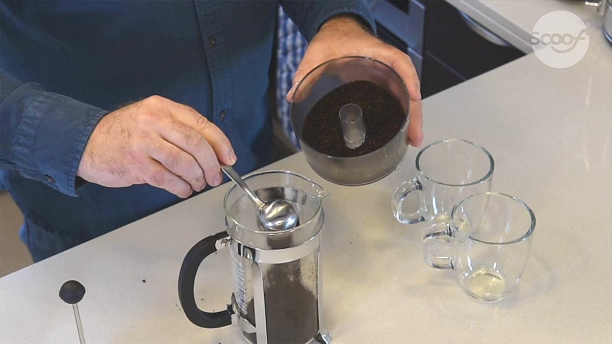 adding ground coffee to a cafetiere